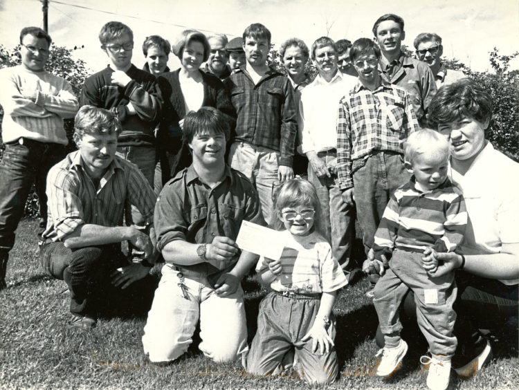 1990 - A £690 cheque raised at a barn dance and barbecue is  handed over for Crichton House at Easter Anguston