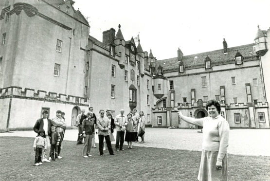 1986 - Guide Aileen Forbes points out some of Fyvie Castle’s features to visitors
