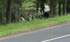 File photo dated 09/07/15 of police officers searching the scene at Junction 9 of the M9 near Stirling where John Yuill and Lamara Bell were discovered. Representatives from Police Scotland will appear at Edinburgh High Court on Tuesday to give evidence in the M9 death crash case. Issue date: Tuesday September 7, 2021. PA Photo. John, 28, and his partner Lamara, 25, died after lying in a crashed car for three days after the incident was first reported to police.