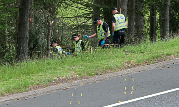 File photo dated 09/07/15 of police officers searching the scene at Junction 9 of the M9 near Stirling where John Yuill and Lamara Bell were discovered. Representatives from Police Scotland will appear at Edinburgh High Court on Tuesday to give evidence in the M9 death crash case. Issue date: Tuesday September 7, 2021. PA Photo. John, 28, and his partner Lamara, 25, died after lying in a crashed car for three days after the incident was first reported to police.