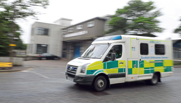 An Ambulance goes past the offices of the Scottish Ambulance Service, Ashgrove Road West, Aberdeen.