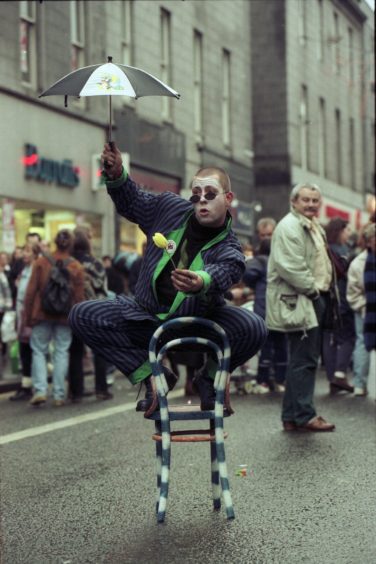 1995: walkabout clown Sean Burn (28), from Aberdeen, entertains shoppers on the busy first day of the Granite City's pedestrianisation of Union Street each Sunday until Christmas.