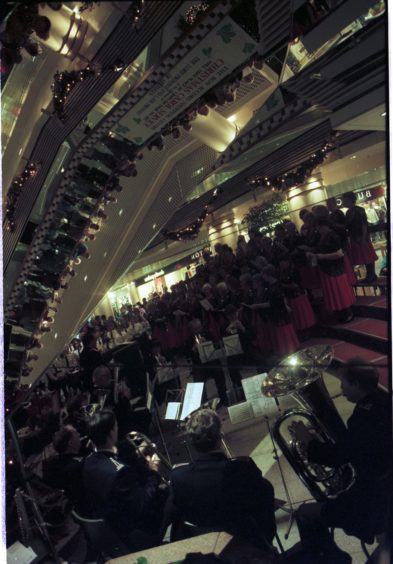 1995: Shoppers get in tune with the festive season at Aberdeen's Bon Accord Centre yesterday during a Christmas carol concert. The mood music was provided by barbershop singing aces the Sweet Adelines, the Salvation Army and St Joseph's school choir.