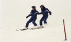 Young skiers go down the hill together in 1996