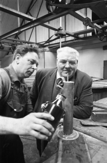 1970: Adam Innes, the distillery brewer of historic Glen Grant Distillery in Rothes, looks at the hydrometer