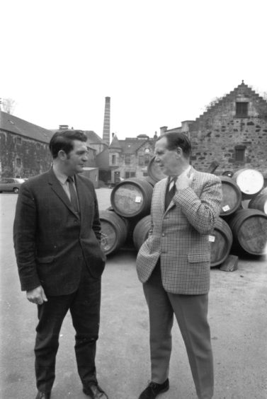 1970: Major Douglas MacKessack, right, managing director of Glen Grant Distillery, chats with the manager Mr E Sherret