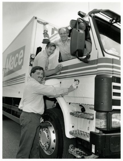 1992: Drivers from Mace wholesalers AR Gray celebrate their success in winning the Alex Hird trophy for best turned-out vehicle during the recent Aberdeen Centre Lorry Driver of the Year competition held at Aberdeen Exhibition and Conference centre. Alastair Rendell celebrates while fellow drivers Robert Leslie and Fraser Adam give the cab a touch of elbow grease.