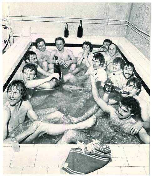 1980: Aberdeen Football Club players celebrating their success with Champagne in the bath. From bottom left, clockwise, Doug Rougvie, Alex McLeish, Andy Watson, Roland Arnott (physio), John McMaster, Gordon Strachan, Stuart Kennedy, Drew Jarvie, Bobby Clark, Doug Bell, Ian Scanlon, Mark McGhee, Willie Miller.