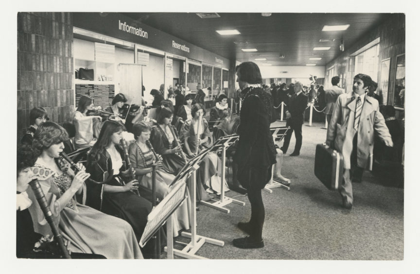 1978: Providing a musical background to the opening of British rail’s new £120,000 travel centre at Aberdeen railway Station are the Kincorth Waits, a group of young musicians from Kincorth Academy, Aberdeen, who specialise in early music.  They are conducted by teacher Charles Foster.