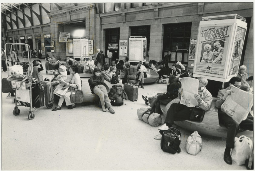 1984: Passengers whose journeys have been disrupted due to industrial action wait on Aberdeen Station concourse.