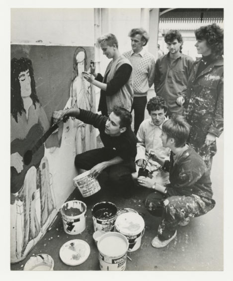 1985: A group of Aberdeen artists work on a public display at the city’s railway station.  Aberdeen City District and British rail have given permission for the artists to give part of the station a colourful facelift in the form of a giant mural.  A group of artists from Aberdeen Community Arts and the Youth Information Centre hit on the idea to paint a mural in the city to mark International Youth year and the council suggested the station as a possible site.