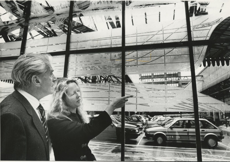 1990: The shipbuilding history of Aberdeen etched onto glass at the Aberdeen railway Station concourse.  Right: Chancellor of the University of Aberdeen Kenneth Alexander discussing the etchings with Aberdonian artist Elizabeth Ogilvie after he unveiled the screen.