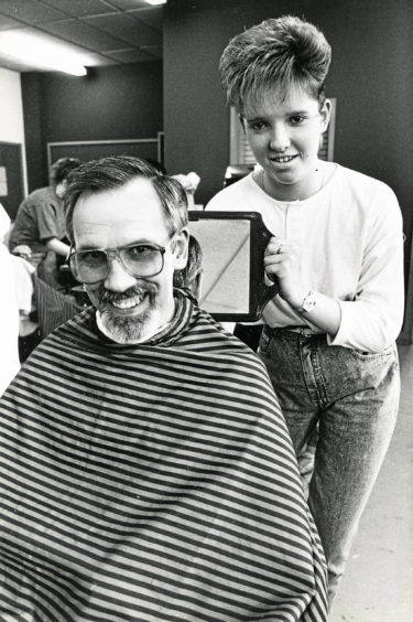 1988: Hairdressing students at Aberdeen Technical College evening classes compete last night to create the perfect "Modern Men's Haircut" Lynn Smith, Dyce, gets to grips with her father, Albert's, locks.