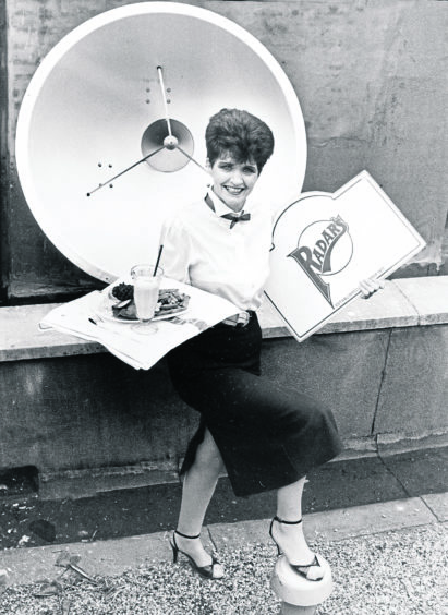 1986: Radars bar and restaurant waitress Rose Maclean braves the elements on the roof terrace