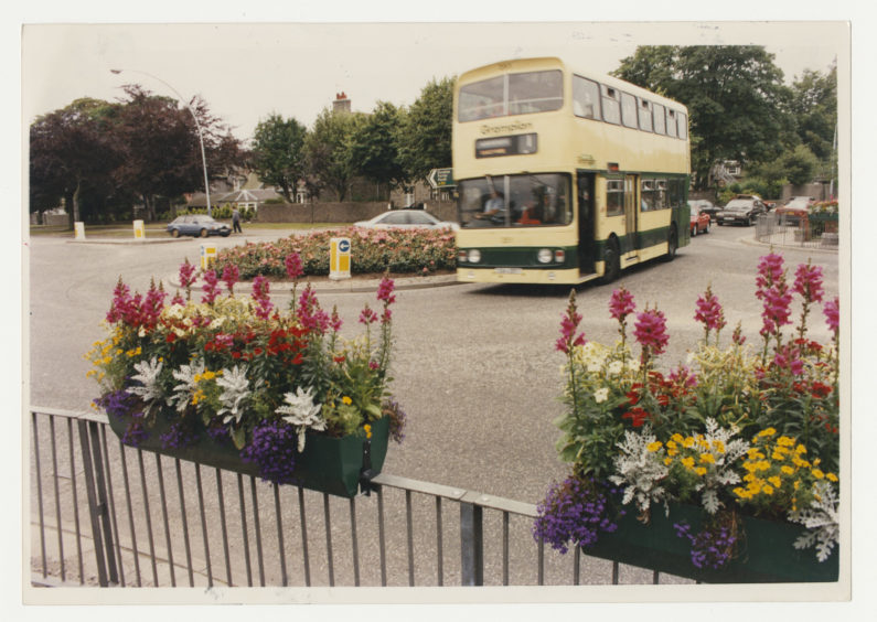 The No 1 bus negotiates the roundabout by the new flower baskets on Anderson Drive, Aberdeen. 29 July 1992.