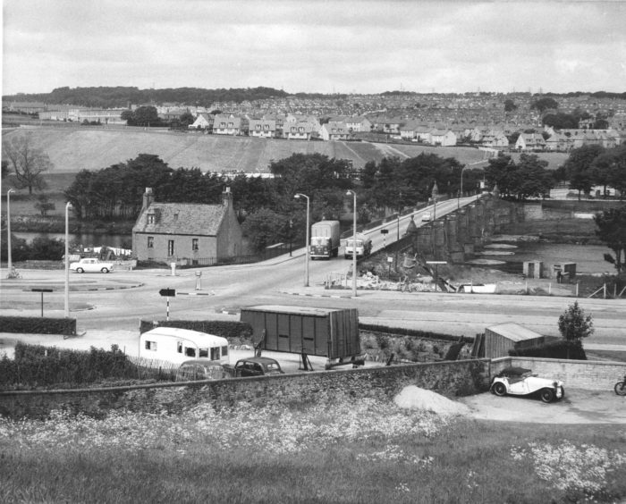 1964: A view of the old Bridge of Dee, Aberdeen, looking north from Kincorth towards Kaimhill, as it was in this picture from June 1964. The volume of traffic was very light with only four vehicles in the photograph.
