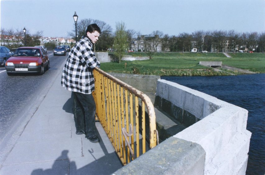 1993: Art and Design student Graeme Robertson, Inverness, looks at the parapet at Bridge of Dee.