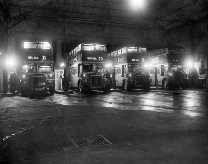 1961: A line of buses are refuelled at the Aberdeen Corporation Transport depot ready for the day.