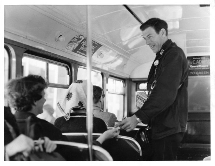 1965: : Bus conductor Andrew Fraser at work as a bus makes its way through the city.
