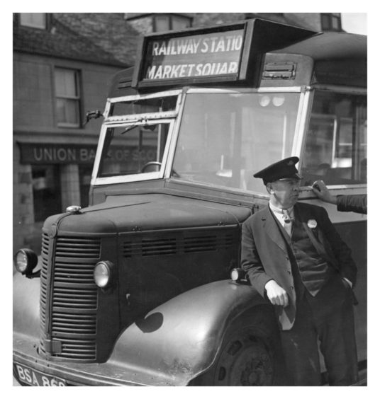1949: Peter Stewart, a bus driver in Stonehaven, takes a well-earned break.