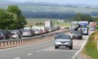 Police officers at the scene on the A90 Dundee to Aberdeen road at Laurencekirk Friday July 2