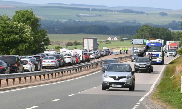 Police officers at the scene on the A90 Dundee to Aberdeen road at Laurencekirk Friday July 2