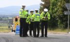 Police officers at the scene on the A90 Dundee to Aberdeen road at Laurencekirk. Photo: Chris Sumner/DCT Media