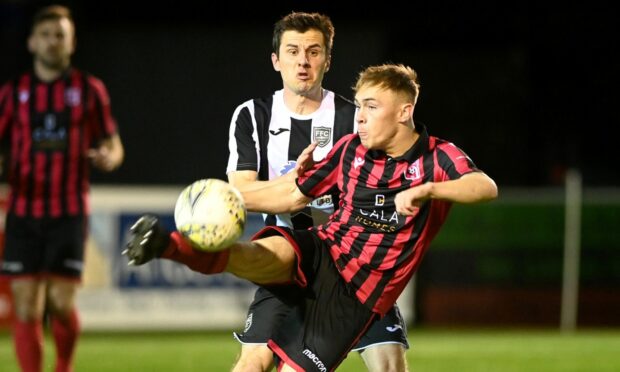 Inverurie Locos forward Nathan Meres, front, in action against Fraserburgh