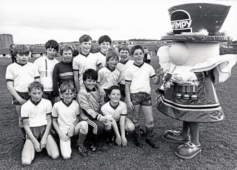 1987: 65th Milltimber Cubs football captain Michael Milne receives the Dee District Cubs Wimpy League Cup after beating 4th Aberdeen 4-2 in a play-off at Balgownie