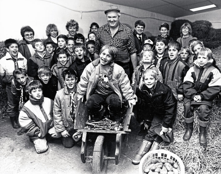 1987: Farm manager John Robertson with eight-year-old Ashley Painter and the American School Cub Scout pack during a visit to Easter Anguston Farm