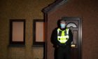 A police officer stands guard outside the property in Cove's Allison Close after the body of Christina Malley was found.