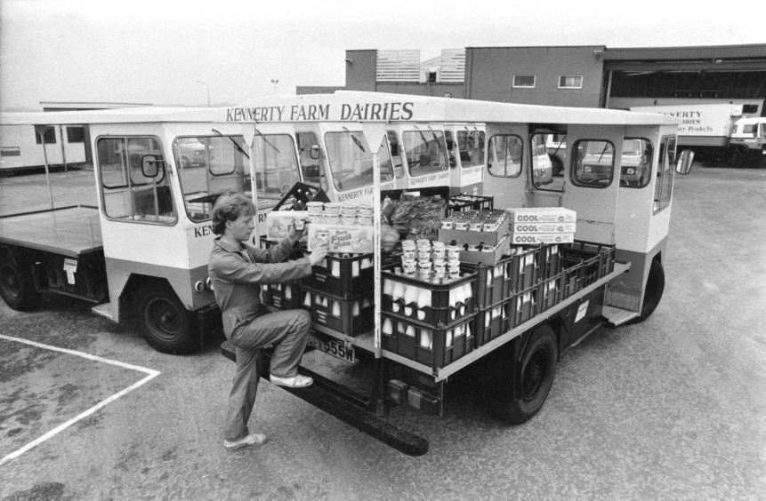 1983: Loading the electric milk float with a selection of the various products which the modern milkman now delivers
