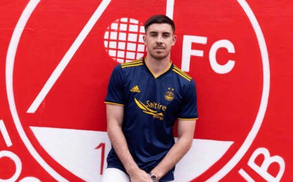 Declan Gallagher in the new Dons away kit.
