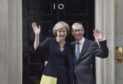 Theresa May and her husband Philip John outside 10 Downing Street.