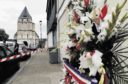 atrocity:  Flowers outside a French church where a priest was murdered.