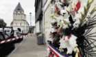 atrocity:  Flowers outside a French church where a priest was murdered.