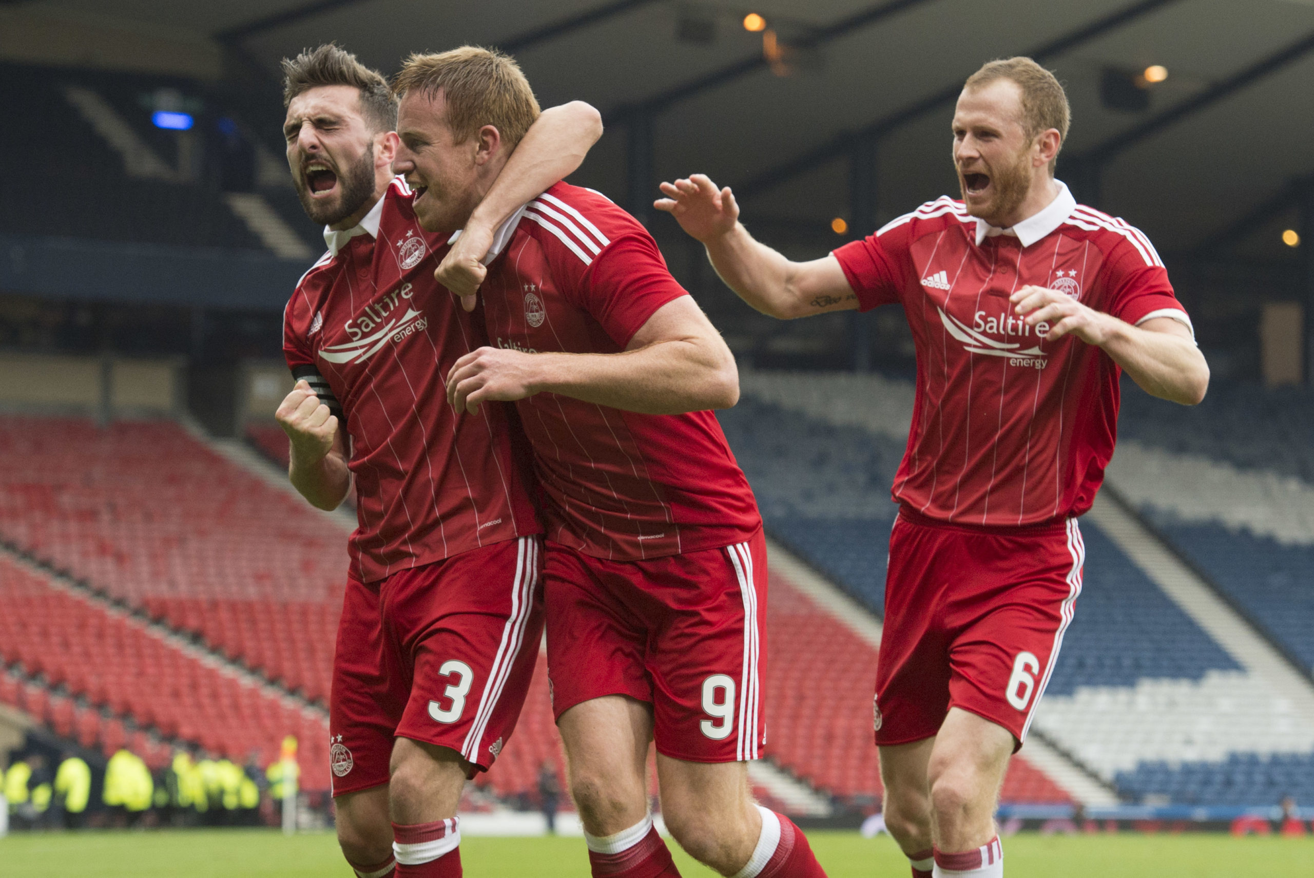 Mark Reynolds, right, and Graeme Shinnie, left, celebrate Adam Rooney’s vital Betfred Cup goal against Morton at Hampden.