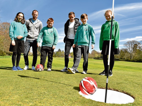 Dons players Mark Reynolds and Peter Pawlett play footgolf at Hazlehead with pupils from Hazlehead Primary School.
