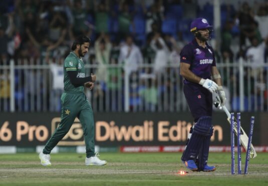 Pakistan's Hasan Ali, left, celebrates the dismissal of Scotland captain Kyle Coetzer