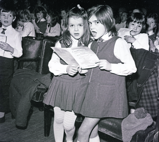 1974: These girls look startled by the photographer, who also caught the attention of the little lad behind