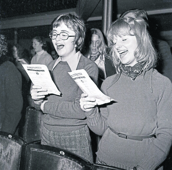 1977: Two ladies giving it their all during the 1977 carol concert