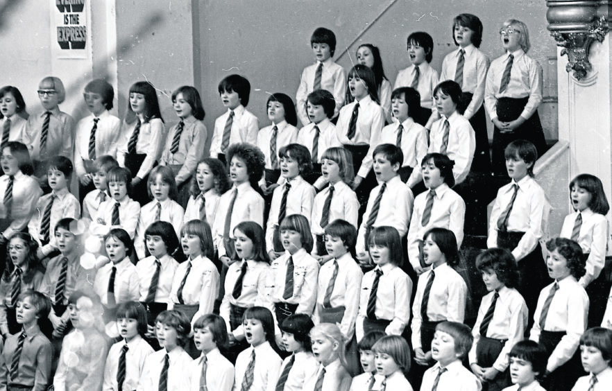 1978: Youngsters spreading festive cheer and goodwill with some carols