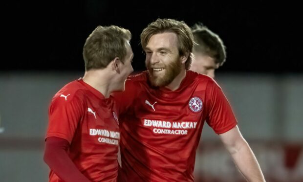 Dale Gillespie (right) celebrates scoring against Fort William with Ally MacDonald.
