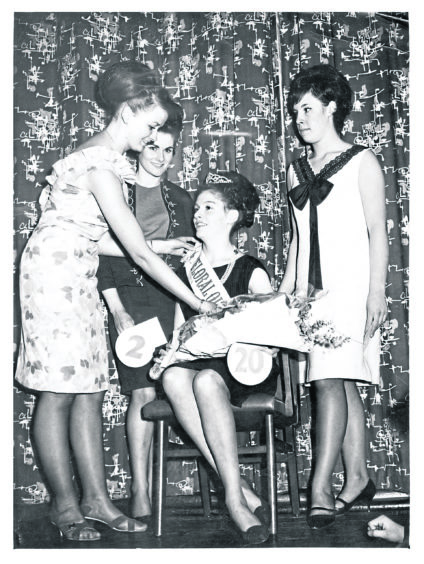 1966: Lovely Sylvia Lamont, of Glenbervie Road, is crowned Aberdeen's Floral Queen in February 1966 by the outgoing queen, Mrs J. Winning, at the St. Valentine's Mod Ball in the Beach Ballroom. A pupil of Aberdeen High Schools for girls, Sylvia was chosen from a shortlist of six girls.