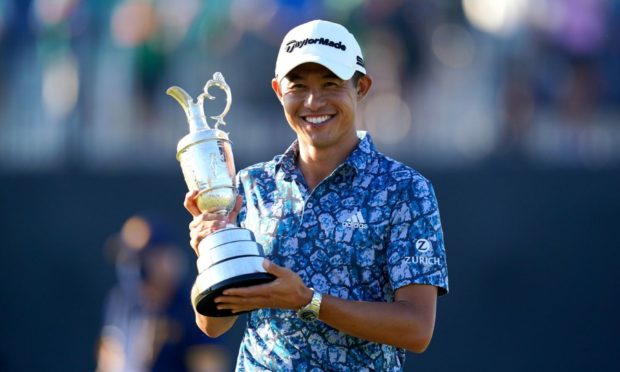 Collin Morikawa celebrates with the Claret Jug after winning the Open.
