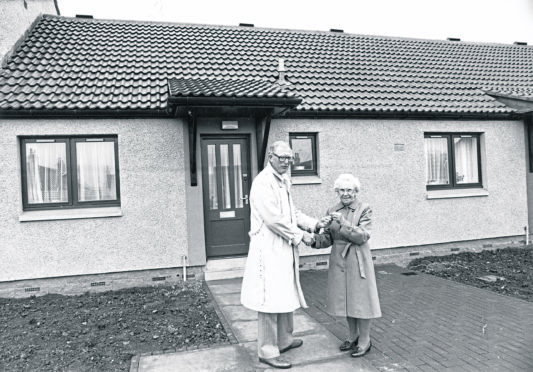 Margaret Shearer receives the keys to the first Scottish Special Housing Association house to be occupied after being built on the site of the old Orlit type