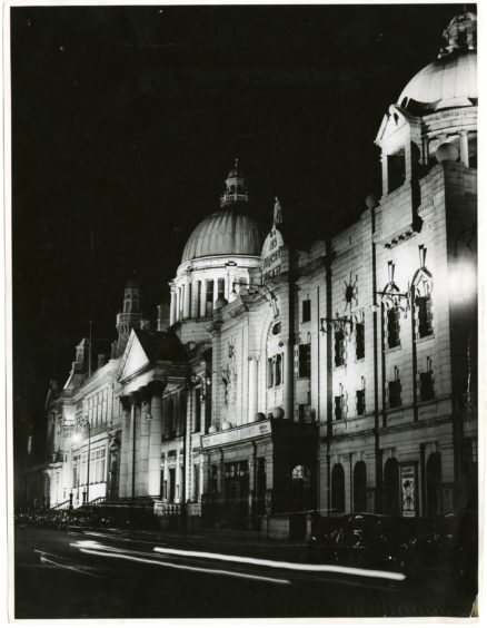 1952: A nighttime scene of HM Theatre, South Church and Aberdeen Central Library on Rosemount Viaduct, Aberdeen.