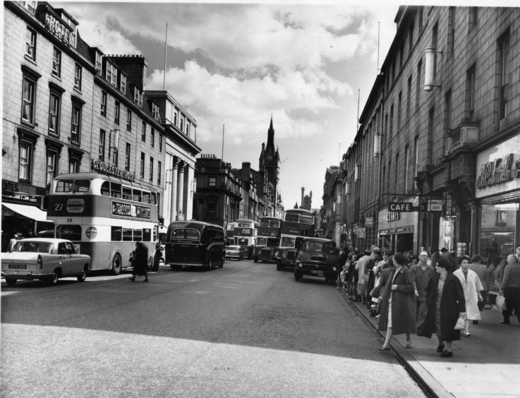 View of Union Street with traffic and pedestrians. Gloucester Hotel on left,  shops on right.