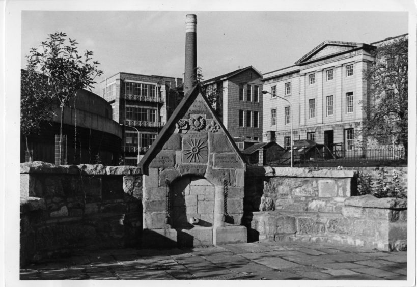 1981: The Spa Well in its present location at the south-east end of Spa Street with the Royal Infirmary, Woolmanhill in the background.
