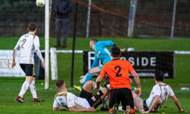 Rothes' Alasdair Stark (No 2) watches as his strike goes the wrong side.of the post.